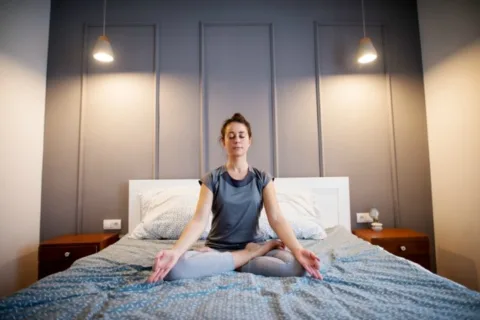 This is an example of the Seated Meditation pose - simple yoga exercises for easy yoga in bed.