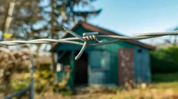 Barbed wire with blurred background of a house